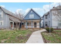 Charming blue two-story home with inviting front porch and well-maintained lawn at 324 W 7Th St, Anderson, IN 46016