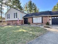 Charming home with a well-manicured lawn and a welcoming brick facade at 3515 Autumn Ct, Columbus, IN 47203