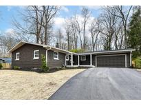 A beautiful brown home featuring a new driveway and an attached garage at 4625 Berkshire Ln, Indianapolis, IN 46226