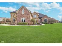 Inviting two-story brick home with a manicured lawn and beautiful landscaping at 519 Southwind, Brownsburg, IN 46112