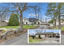 View of charming two-story home with detached four car garage and beautifully landscaped front yard at 8146 W 875 S, Pendleton, IN 46064