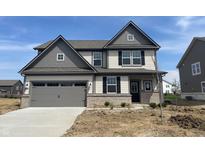 Charming two-story home featuring a two-car garage and a mix of siding and brick accents at 8893 Alexander Ridge Dr, McCordsville, IN 46055