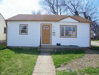 Charming single-story home with a well-maintained lawn and inviting front entrance at 90 N 6Th Ave, Beech Grove, IN 46107