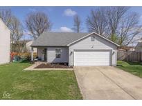 Charming single-story home featuring a two-car garage and a well-maintained front lawn at 10946 Snowdrop Way, Indianapolis, IN 46235