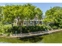 Waterfront home featuring a lakeside view, outdoor seating, mature trees, and a multi-tiered deck at 1326 White Water Ct, Cicero, IN 46034