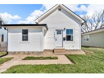 Charming single-story home featuring a well-manicured lawn, stone foundation, and freshly painted exterior at 1924 S A St, Elwood, IN 46036