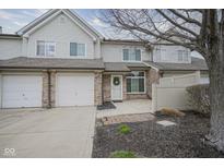 Two-story townhouse featuring a single car garage, brick accents, and well-maintained landscaping at 256 Strand Ln # Apt C, Avon, IN 46123