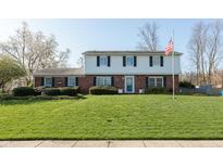 Charming two-story home featuring a manicured lawn and a classic brick and siding facade at 3039 Rolling Springs Dr, Carmel, IN 46033