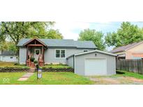 Charming single-story home with a gray exterior, covered porch, and well-maintained landscaping at 316 Laurel St, Pendleton, IN 46064
