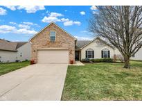 Charming single-Gathering home with a well-manicured lawn and an attached two-car garage at 5877 W Nautica Blvd, McCordsville, IN 46055