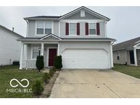 Charming two-story home with gray siding, red shutters, and a well-maintained front yard at 639 Rocky Meadow Dr, Greenwood, IN 46143