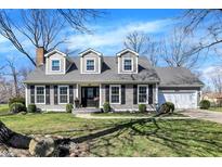 Charming two-story home with gray siding, black shutters, manicured lawn, and beautiful landscaping at 6820 W Forest Brook Dr, Fountaintown, IN 46130