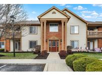 Inviting condominium building entrance with well-maintained landscaping and a welcoming front door at 8920 Hunters Creek Dr # 101, Indianapolis, IN 46227