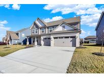 Charming two-story home featuring a two-car garage and a well-manicured front yard on a sunny day at 950 Edmonds Pl, Greenwood, IN 46143