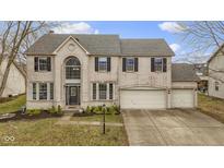 Charming two-story home with a three-car garage and brick exterior, enhanced by a well-manicured lawn at 11046 Timberview Dr, Fishers, IN 46037