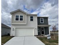 Two-story home showcasing a two-car garage, gray and white siding, and professionally installed landscaping at 11812 Vale St, Indianapolis, IN 46235