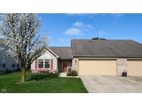 Charming single-story home with attached garage, landscaped lawn, and flowering tree at 1304 Vicksburg S Dr, Greenwood, IN 46143