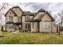 Charming, two-story brick home with beautiful landscaping and a well-maintained front lawn at 14818 Autumn View Way, Fishers, IN 46037