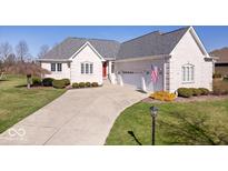 Charming single-Gathering home featuring a well-manicured lawn and an attached two-car garage at 17279 Crescent Moon Dr, Noblesville, IN 46060
