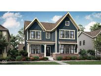 Charming two-story home with a combination of brick and siding and professionally landscaped front yard at 20211 Chad Hittle Blvd, Westfield, IN 46074