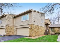 Inviting exterior view of a multi-level home with stone accents and a convenient attached garage at 307 Baywood Ct # 67, Noblesville, IN 46062