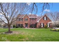 Stunning two-story brick home featuring a well-manicured lawn and beautiful landscaping at 3976 Bent Tree Ln, Greenwood, IN 46143