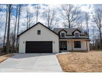 New construction modern farmhouse featuring a black garage door and coordinating window trim at 5123 Oak Ridge Pl, Columbus, IN 47201