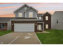 Charming two-story home featuring a two-car garage, brick accents, and a welcoming front lawn at 5150 Bramwell Ln, Whitestown, IN 46075