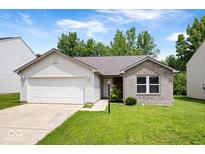 Charming single-story home featuring a brick facade, attached garage, and well-manicured lawn at 5842 Minden Dr, Indianapolis, IN 46221