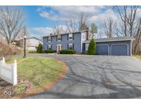 Two-story blue home with a two-car garage, front lawn, and a long, curved driveway at 619 Lawnwood Dr, Greenwood, IN 46142
