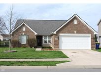 Charming single-story brick home with well-manicured lawn and attached two car garage at 6418 W Oxford Ln, McCordsville, IN 46055