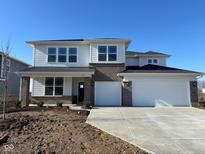 New two-story home featuring a brick and siding exterior with a large three-car garage at 7206 Dylan Dr, Brownsburg, IN 46112