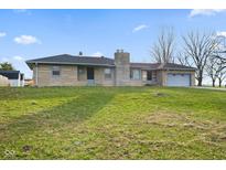 Charming single-story home features a stone exterior, covered front porch and attached garage on a sunny lot at 791 S Us Highway 31, Whiteland, IN 46184