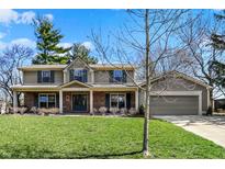 Charming two-story home featuring a brick facade and lush green lawn at 9017 Ironwood Ct, Indianapolis, IN 46260
