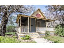 Charming home featuring a welcoming front porch, complemented by mature trees and landscaping at 1542 Maple Ave, Noblesville, IN 46060