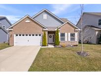 Charming single-Gathering home featuring a brick facade, attached garage and well maintained front yard at 16566 Branham Dr, Fishers, IN 46040
