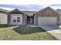 Charming brick home featuring an attached two car garage and a cozy front porch at 19518 Hurst Strand Way, Noblesville, IN 46062