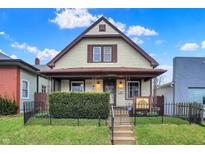 Charming two-story home featuring a well-maintained lawn and a classic design at 2023 Shelby St, Indianapolis, IN 46203