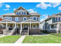 Charming two-story home featuring a welcoming front porch and well-maintained lawn with lovely landscaping at 2352 N College Ave, Indianapolis, IN 46205