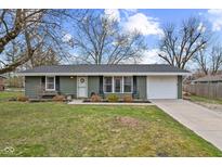 Charming single-story home with an attached garage, well-maintained lawn, and inviting curb appeal at 2823 Shakespeare Dr, Southport, IN 46227