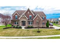 Charming two-story brick home with stone accents, manicured lawn, and well-maintained landscaping at 3240 Wildlife Trl, Zionsville, IN 46077