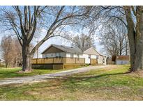 Charming single-story home with a front yard, wooden deck, gravel driveway and storage shed at 3721 S 575 W, Trafalgar, IN 46181