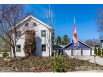 Charming two-story home with a gravel driveway and detached garage with a 'For Sale' flag at 3926 Rookwood Ave, Indianapolis, IN 46208