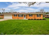 Charming single-story brick home with a well-manicured lawn and attached garage at 3929 Lee St, Anderson, IN 46011