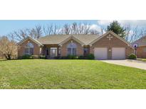Charming single-story brick home with manicured lawn and two-car garage at 400 S Prairie Trce, Muncie, IN 47304