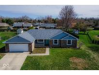 Well-maintained single-story home featuring a brick exterior, attached garage, and a freshly cut lawn at 511 Windward Ln, Plainfield, IN 46168