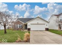 Charming single-Gathering home featuring a two-car garage, brick accents, and a well-maintained lawn at 714 Breakers Ln, Fortville, IN 46040