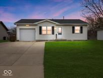 Charming single-story home with a well-maintained lawn and attached garage at 809 E Mckay Rd, Shelbyville, IN 46176