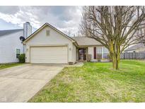 Charming single-story home with a well-maintained lawn and attached two-car garage at 8314 Corinth Pl, Indianapolis, IN 46227
