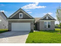Charming single-story home with a two-car garage, well-maintained lawn, and neutral brick facade at 1023 Grassy Br Dr, Indianapolis, IN 46239